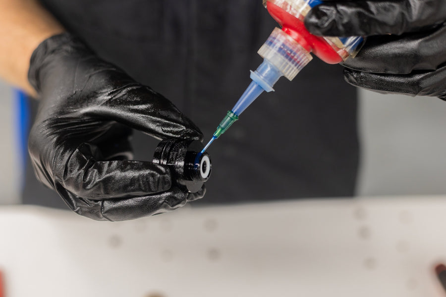 Applying blue Loctite to air seal head threads